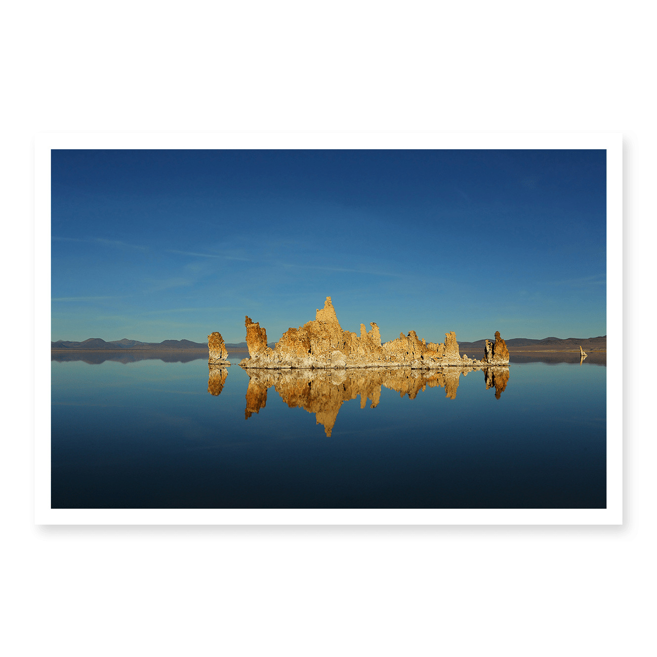 Fine art photograph of Mono Lake’s calm waters reflecting tufa rock formations, taken by Fred Moser.